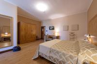 A bed or beds in a room at Leone de Castris Wine Hotel