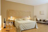 A bed or beds in a room at Leone de Castris Wine Hotel