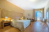 A bed or beds in a room at Leone de Castris Wine Hotel