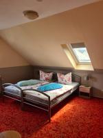 a attic bedroom with two beds and a window at Ferienwohnung Fiehn in Schwedt