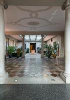 an empty lobby with a checkered floor and plants at Monaco &amp; Grand Canal in Venice