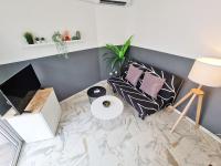 a living room with a marble floor with pillows and a table at GregBnb-com - T2 Pleine Ville - CLIMATISE - BALCON - 1 in Toulon