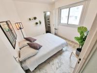 a white bedroom with a bed and a window at GregBnb-com - T2 Pleine Ville - CLIMATISE - BALCON - 1 in Toulon