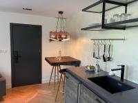 a kitchen with a sink and a counter top at Het Lichthuis in Zandvoort