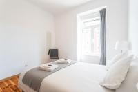 Postel nebo postele na pokoji v ubytování Lisboa Sweet Family Homestay