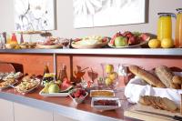 a buffet with many different types of food on a table at Almira Hotel in Arkoudi