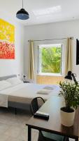 A bed or beds in a room at The Roof Garden - Bed&Breakfast