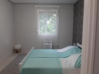 A bed or beds in a room at Jade Vendégház