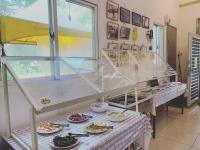 a room with a table with plates of food on it at Kitefarm in Dongshan
