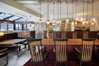 a dining room with a wooden table and chairs at EN HOTEL Hakata in Fukuoka