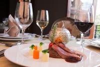 a plate of food on a table with wine glasses at Casa Grande Hotel Boutique in Morelia