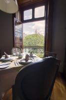 a dining table with a view of a window at Casa Grande Hotel Boutique in Morelia