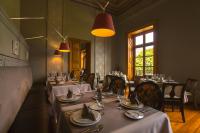 a dining room with tables with white tablecloths and chairs at Casa Grande Hotel Boutique in Morelia
