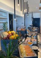 a buffet line with many different types of food at Midenza Seaside & Nature Retreat in Capo Vaticano