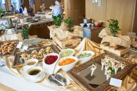 a buffet of food on a table in a kitchen at Beijing Hotel Minsk in Minsk