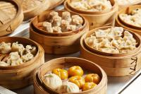 a group of wooden bowls filled with different types of food at Beijing Hotel Minsk in Minsk
