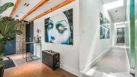 a hallway with art on the walls at Het Lichthuis in Zandvoort