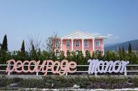 a pink house with a sign in front of it at Decoupage Manor in Jiaoxi