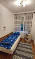 A bed or beds in a room at Kikötő Vendégház