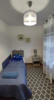 A bed or beds in a room at Kikötő Vendégház