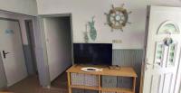 A television and/or entertainment centre at Kikötő Vendégház