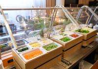 four trays of vegetables on a counter in a restaurant at APA Hotel Kanazawa Ekimae in Kanazawa