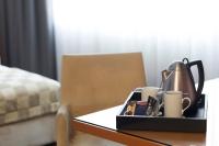 a tray with a tea kettle and cups on a table at Holiday Inn Vienna City by IHG in Vienna