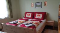 a bedroom with a bed with red pillows at Ferienhaus Renate in Straden