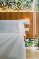 A bed or beds in a room at Collini Rooms Hotel