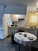 a kitchen with a table with a table cloth on it at Kayenn’Apparts in Cayenne