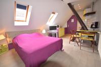 a bedroom with a pink bed and a dining room at Chambres d&#39;hôtes Chez Caroline in Colmar