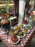 a table with plates of food on a table at Full House Homestay in Yuchi