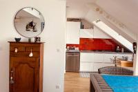 a kitchen with white cabinets and a mirror at **La Bretonnerie, bel appartement de standing in Concarneau