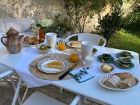 a white table with plates of food on it at Chambres d&#39;hôtes - La Maison 19 in Niort