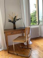 a wooden desk with a chair next to a window at Chambres d&#39;hôtes - La Maison 19 in Niort