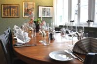 a wooden table with glasses and napkins on it at STF Långholmen Hostel in Stockholm