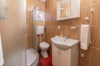 a bathroom with a toilet and a sink and a shower at Apartments Vidik in Ivanjica