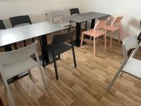 a dining room with tables and chairs and wooden floors at Hostel Little Quarter in Prague