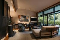 a living room filled with furniture and a large window at Capella Singapore in Singapore