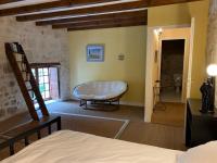 a bedroom with a bed and a bathroom at Gite du moulin in Pranzac