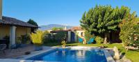 a person playing in a swimming pool in a yard at Un petit coin de Paradis in Mazan