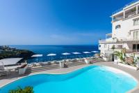 a pool in front of a building with a view of the ocean at Grand Hotel Tritone in Praiano