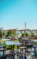 a group of tables and chairs in a park at Lucky Monkey Hotel in Antalya