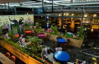 a restaurant with tables and chairs and plants at Lucky Monkey Hotel in Antalya