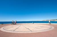 people riding bikes in a circle on the beach at Nice Appart in Nice