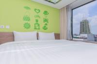 a bedroom with a white bed and a window at Green World Hotel - Zhonghua in Taipei