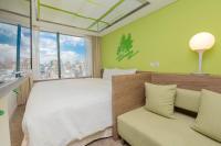 a bedroom with a large bed and a couch at Green World Hotel - Zhonghua in Taipei