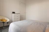 a white bedroom with a bed and a sink at Appartement De Lerme in Bordeaux