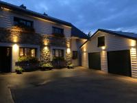 a house with two garage doors in a driveway at Ô Secret du Wérihay in Spa