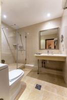 a bathroom with a toilet and a sink and a shower at Renion Park Hotel in Almaty